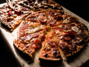 2 Whole Pizzas on a Table