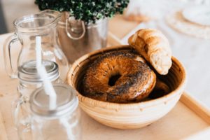 A Bagel & Croissant in a Bowl on a Table